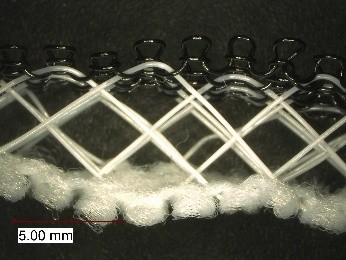 Spacer weft knitted fabrics with three layers, one dence site, with thick monofilaments as spacer yarns and black monofilament knitted fabric on the upper side, all connected as a structure during the knitting